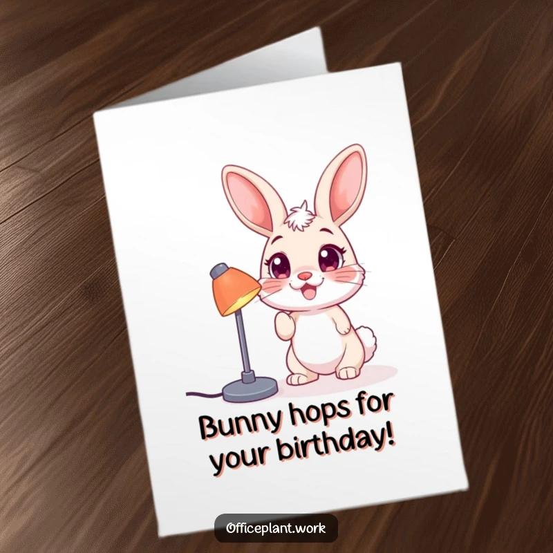 Funny Free Printable Birthday Card: A happy bunny with big eyes nudging a desk lamp with its nose, bringing bright wishes.