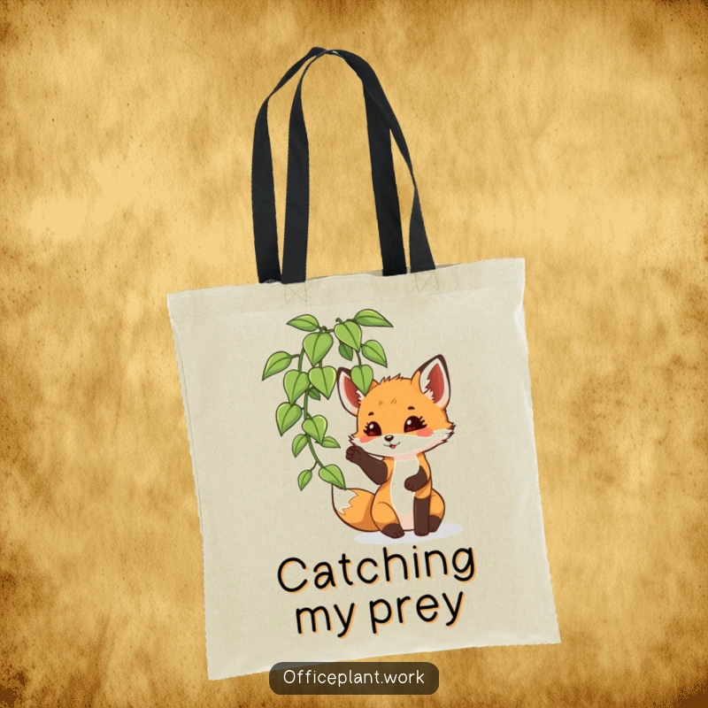 Funny fox cub tote bag, playfully batting at an office plant leaf, designed for carrying items with woodland humor.
